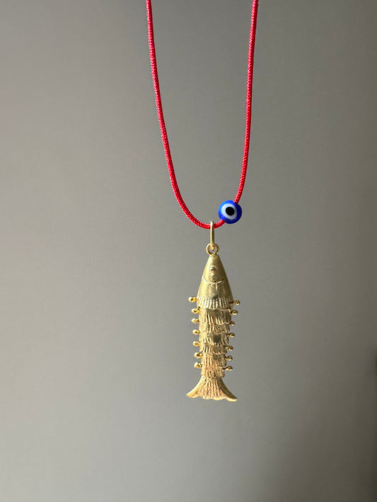 Articulated fish on a red string necklace