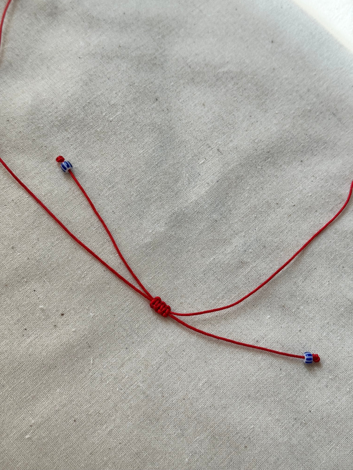 Papillon red cord necklace