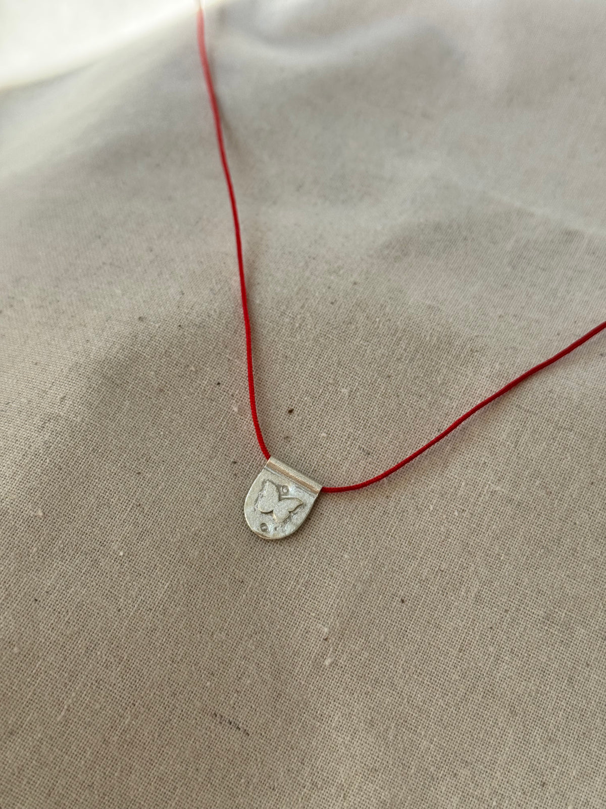 Papillon red cord necklace