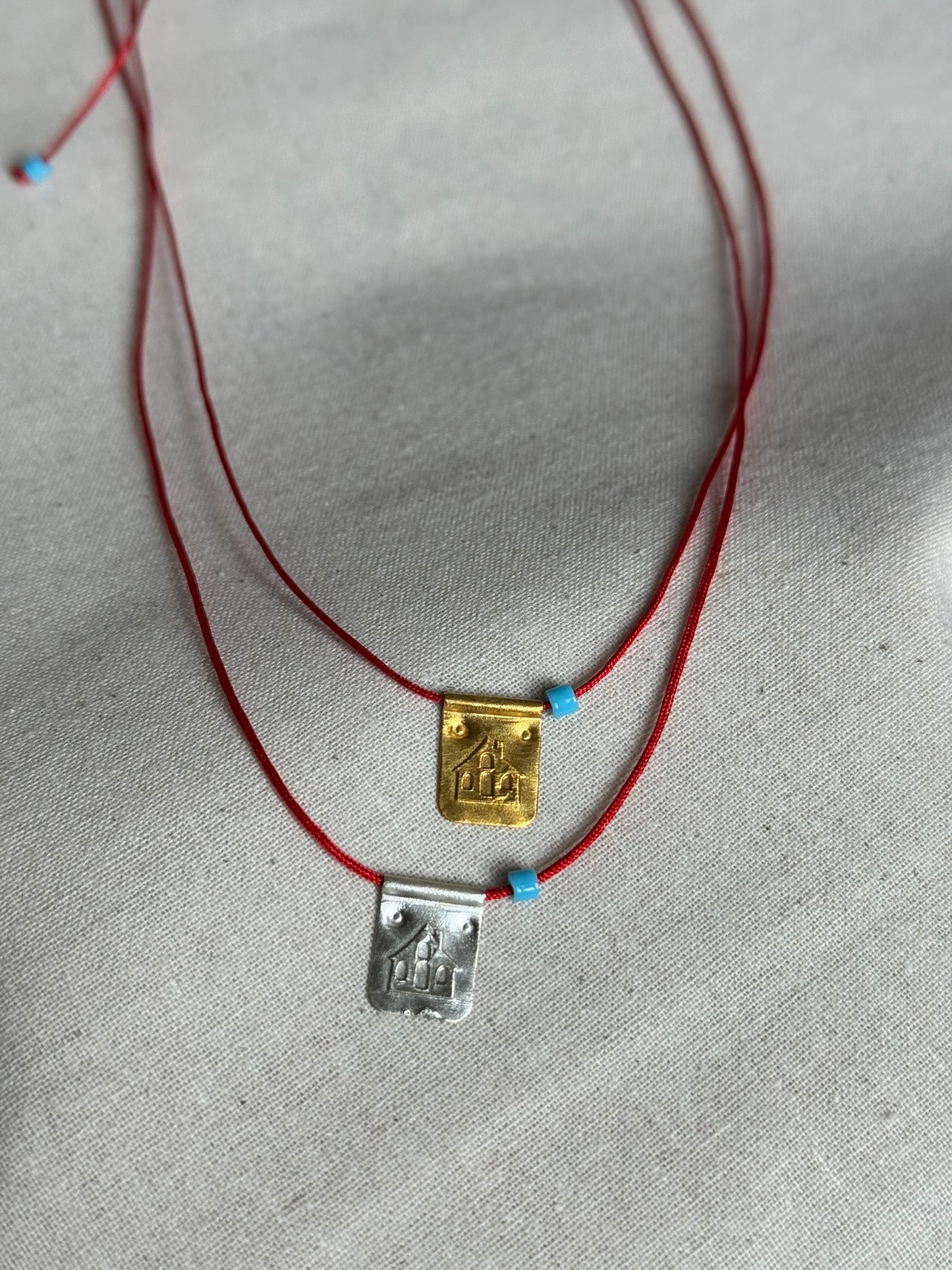 Red string house necklace