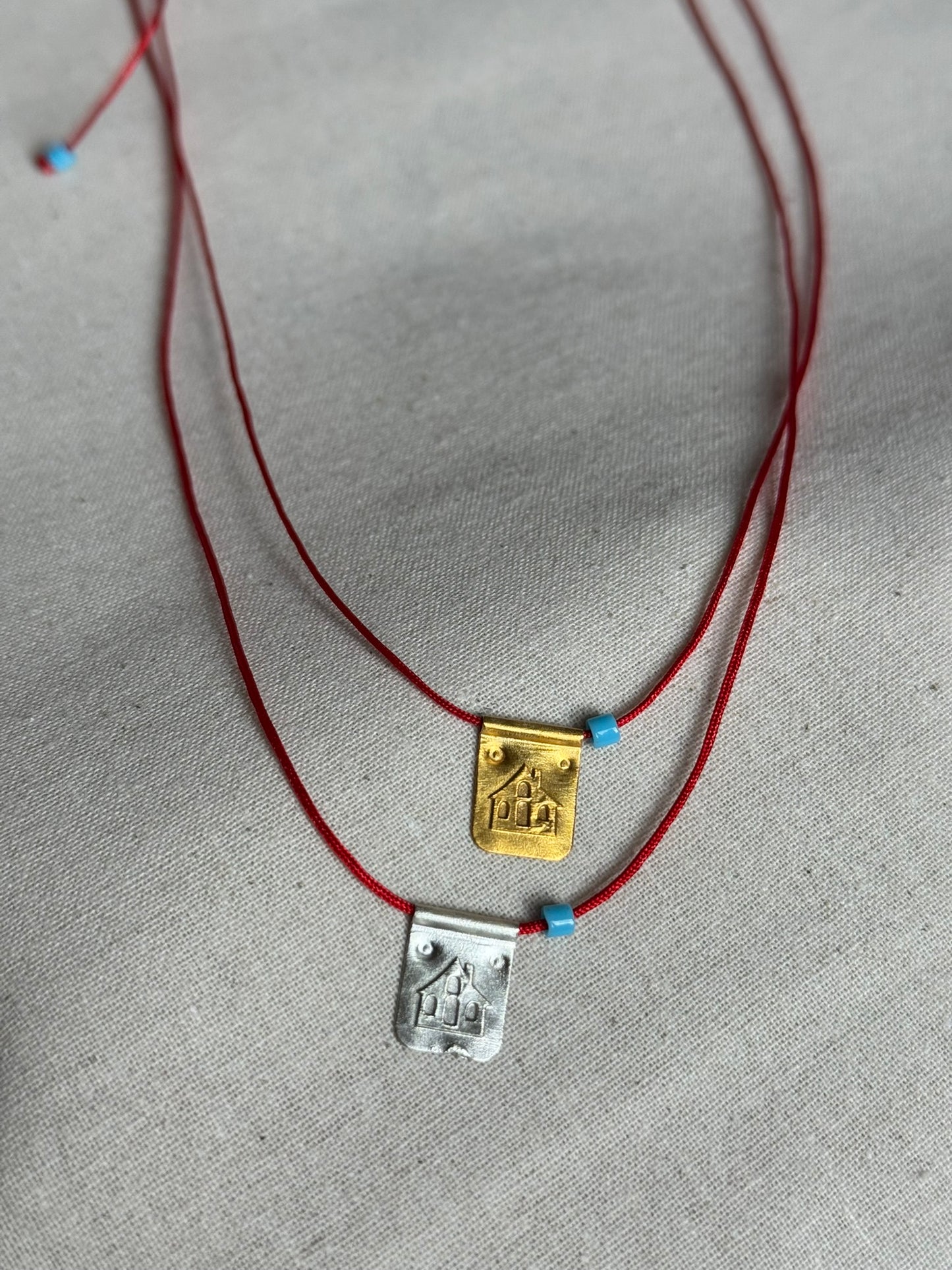 Red string house necklace