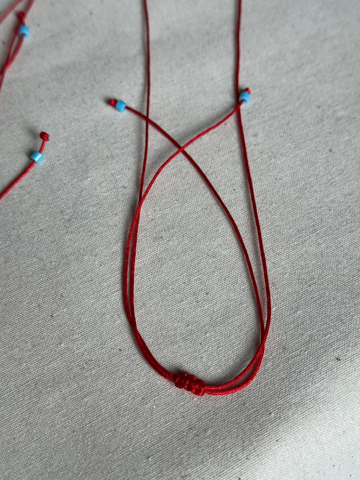 Red string house necklace