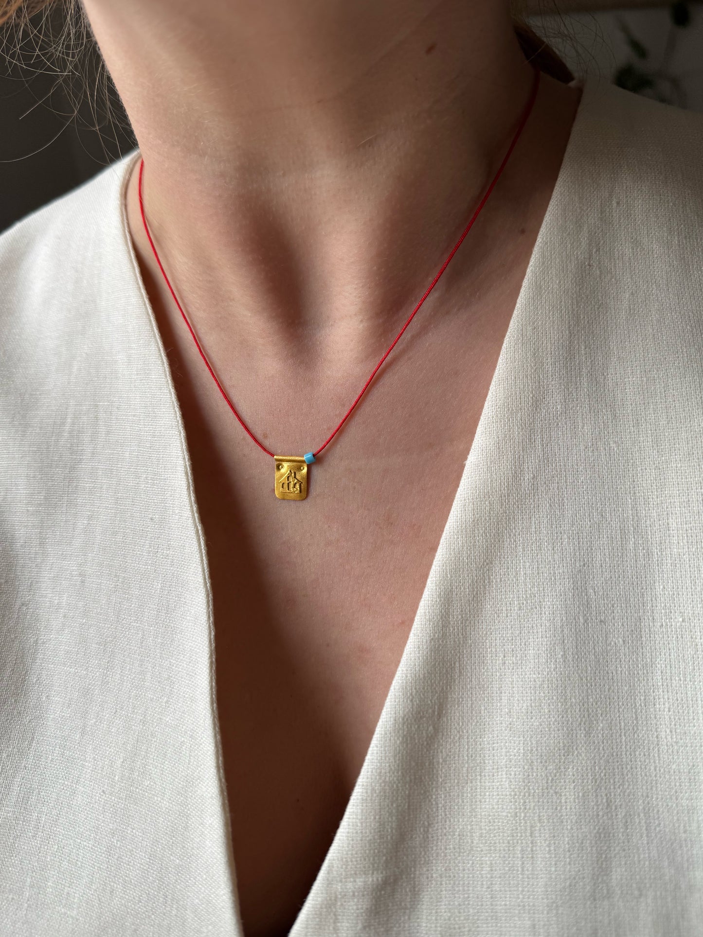 Red string house necklace