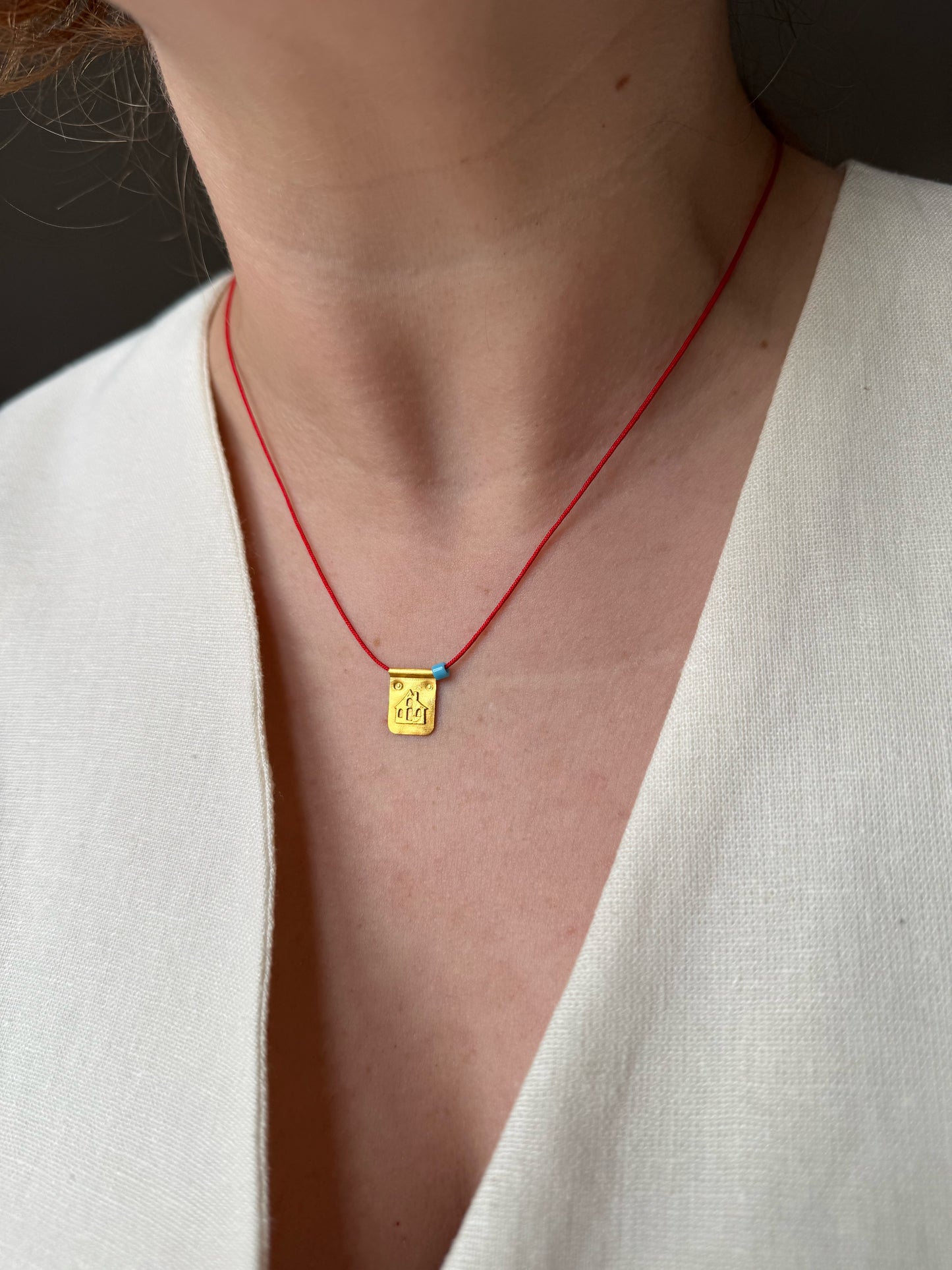 Red string house necklace