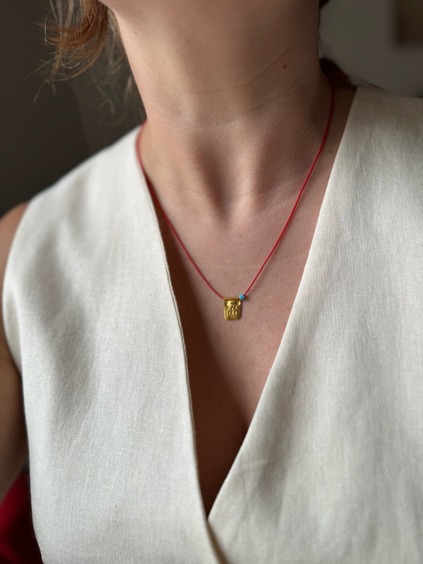 Red string house necklace