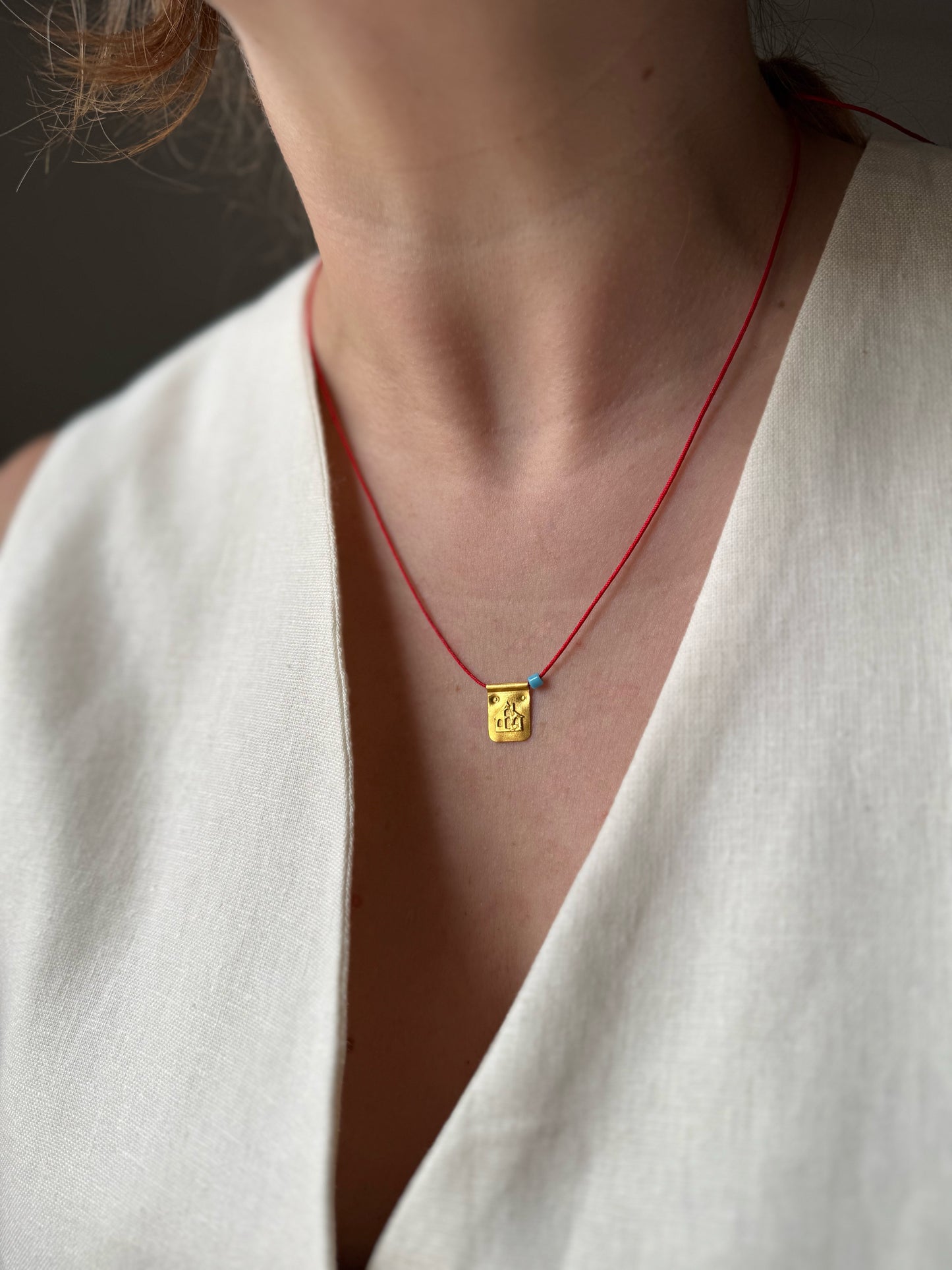 Red string house necklace