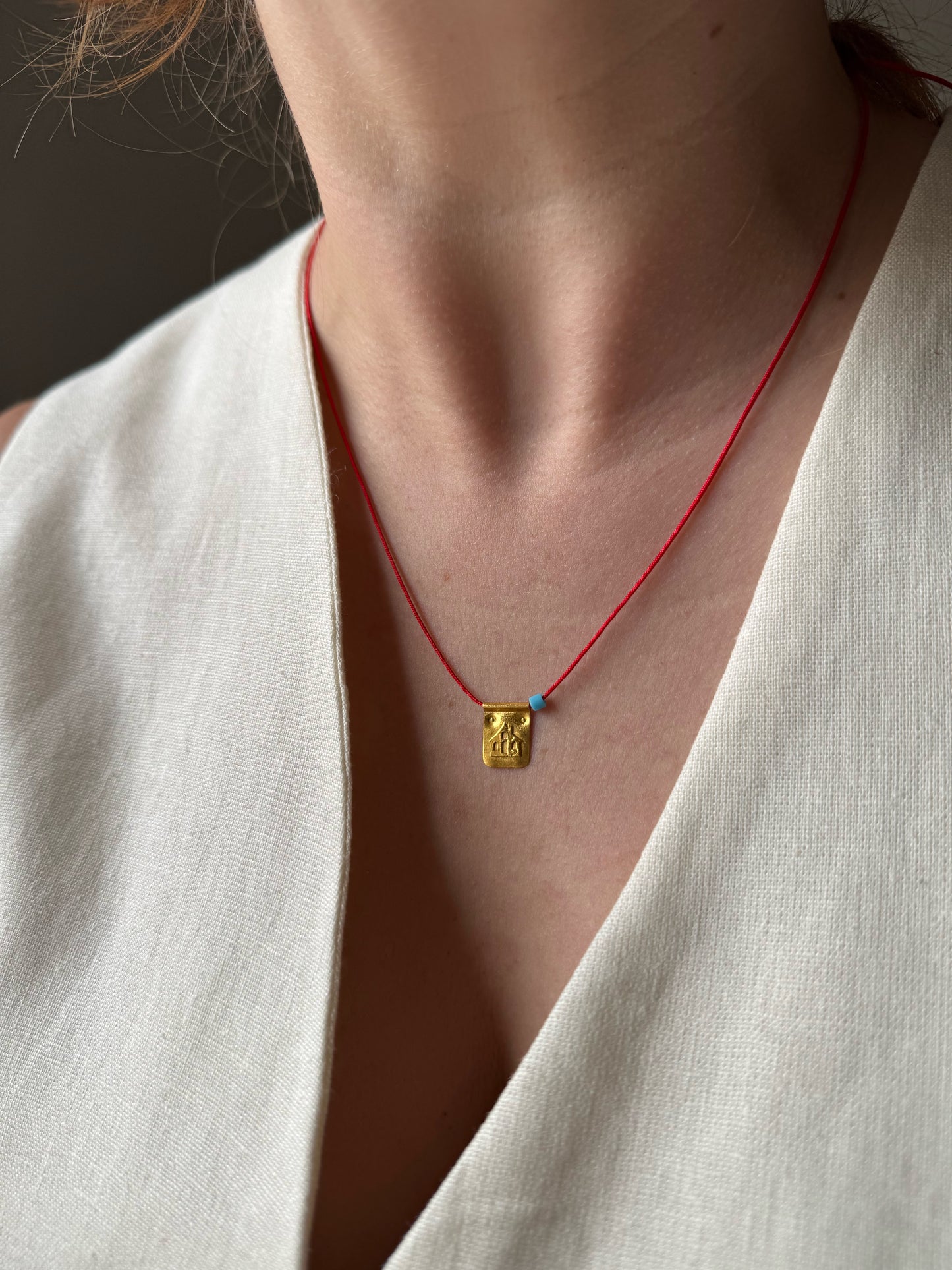 Red string house necklace